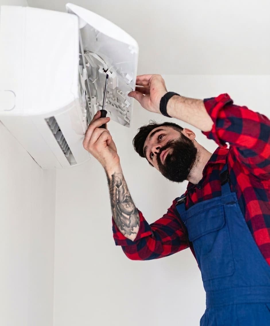 HVAC technician installing an indoor air conditioning unit