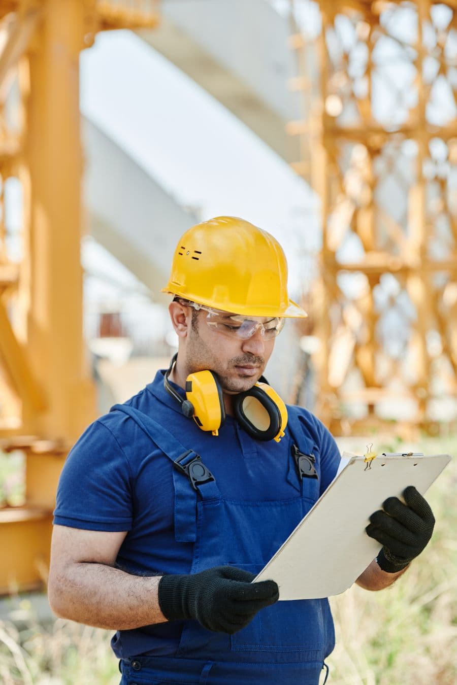 Certified roofing inspector reviewing a project checklist on site